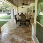 Backyard patio with large dining tables and chairs