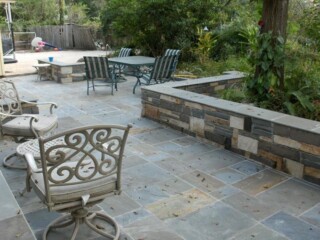 Penn full color cut stone patio with random stone sitting wall.