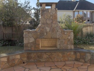 Moss rock outdoor fireplace and benches