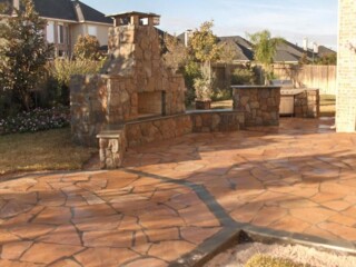 Mossrock fire place with sitting bench and Arizona flagstone patio