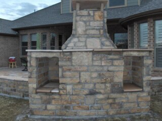 Multi size Oklahoma chop rock fireplace with wood storage spaces