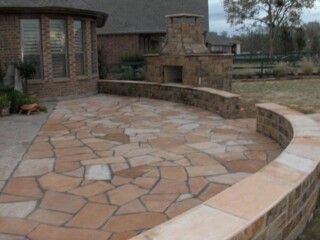 Chop rock sitting wall with buckskin tops and patio.
