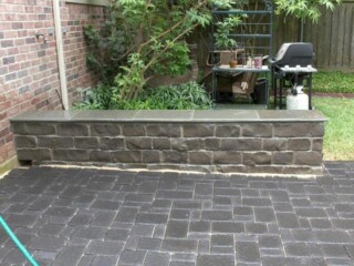 Charcoal 3 pc. paver patio with ozark blue chop rock sitting bench with penn full color tops.