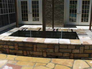 Oklahoma chop rock planter box/ sitting wall with arizona buckskin patio.
