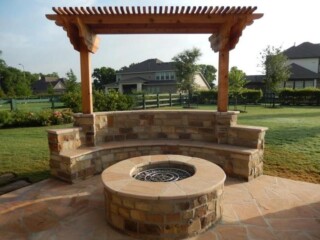 Oklahoma chop rock firepit with Arizona flagstone tops and Arizona flagstone patio, bench with cedar cantilever pergola
