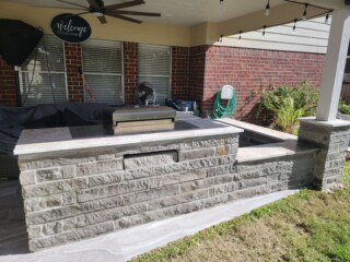 Charcoal chop rock capped with Nordic silver travertine, sitting bench and post column