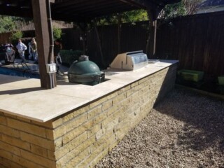 Kitchen with bar topped with travertine