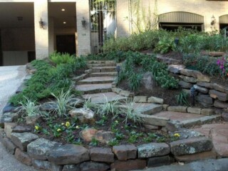 Oklahoma flagstone steps with mossrovks and chop rock borders and landscaping