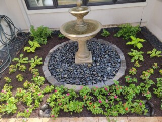 Traditional tiered fountain with blackstar gravel and choprock perimeter